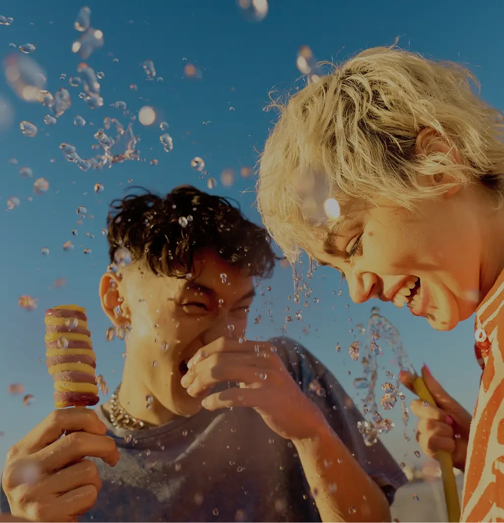 Two young people having fun while eating ice cream